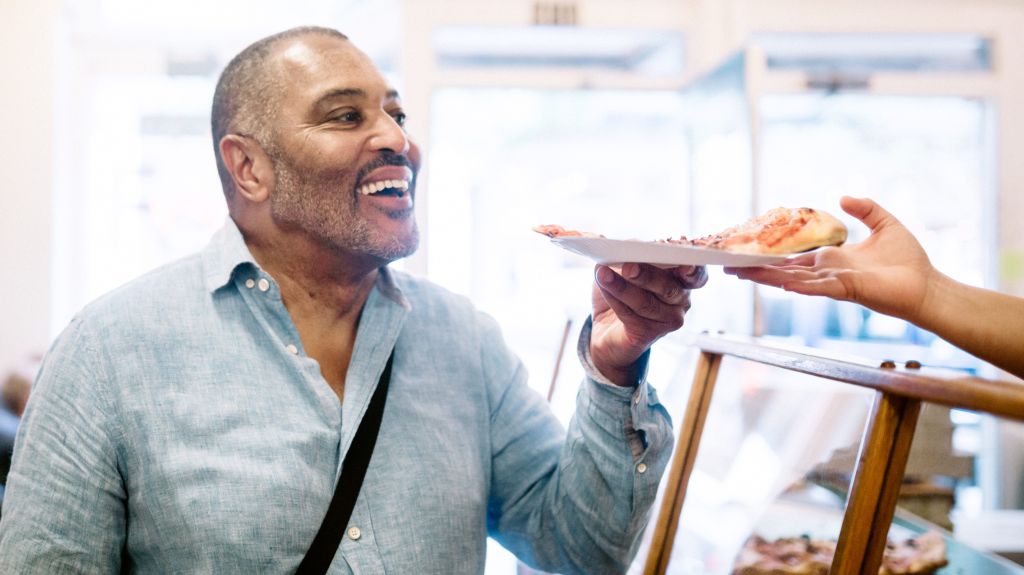 Mature Man Ordering Pizza Slice