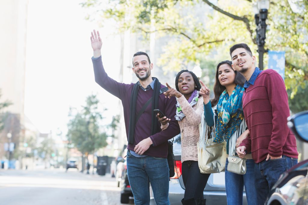 Multi-ethnic group of young adults waiting for ride