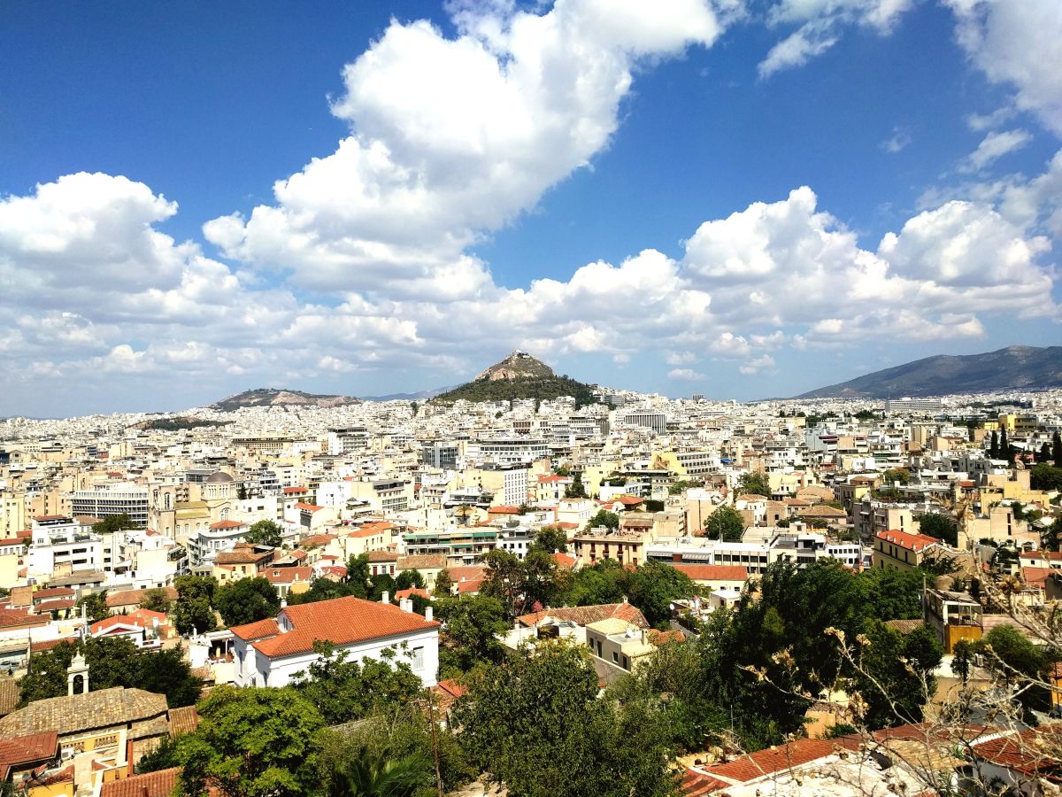 View Of Cityscape Against Cloudy Sky