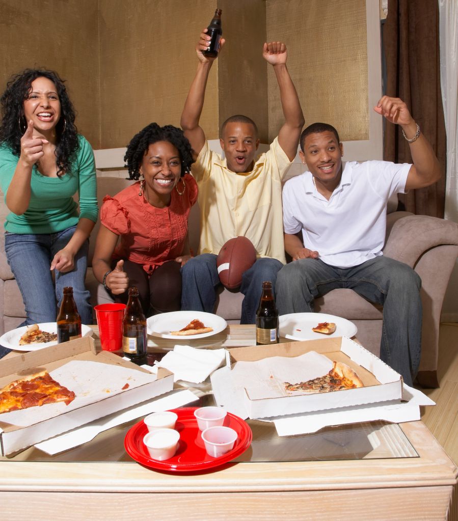 Multi-ethnic friends watching sports on television