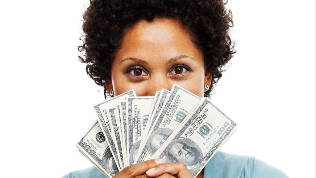 Portrait of an African woman holding US paper currency