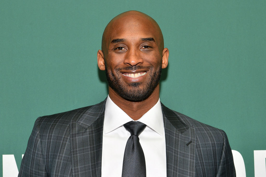 Kobe Bryant Signs Copies Of His Book "Training Camp (The Wizenard Series #1)"