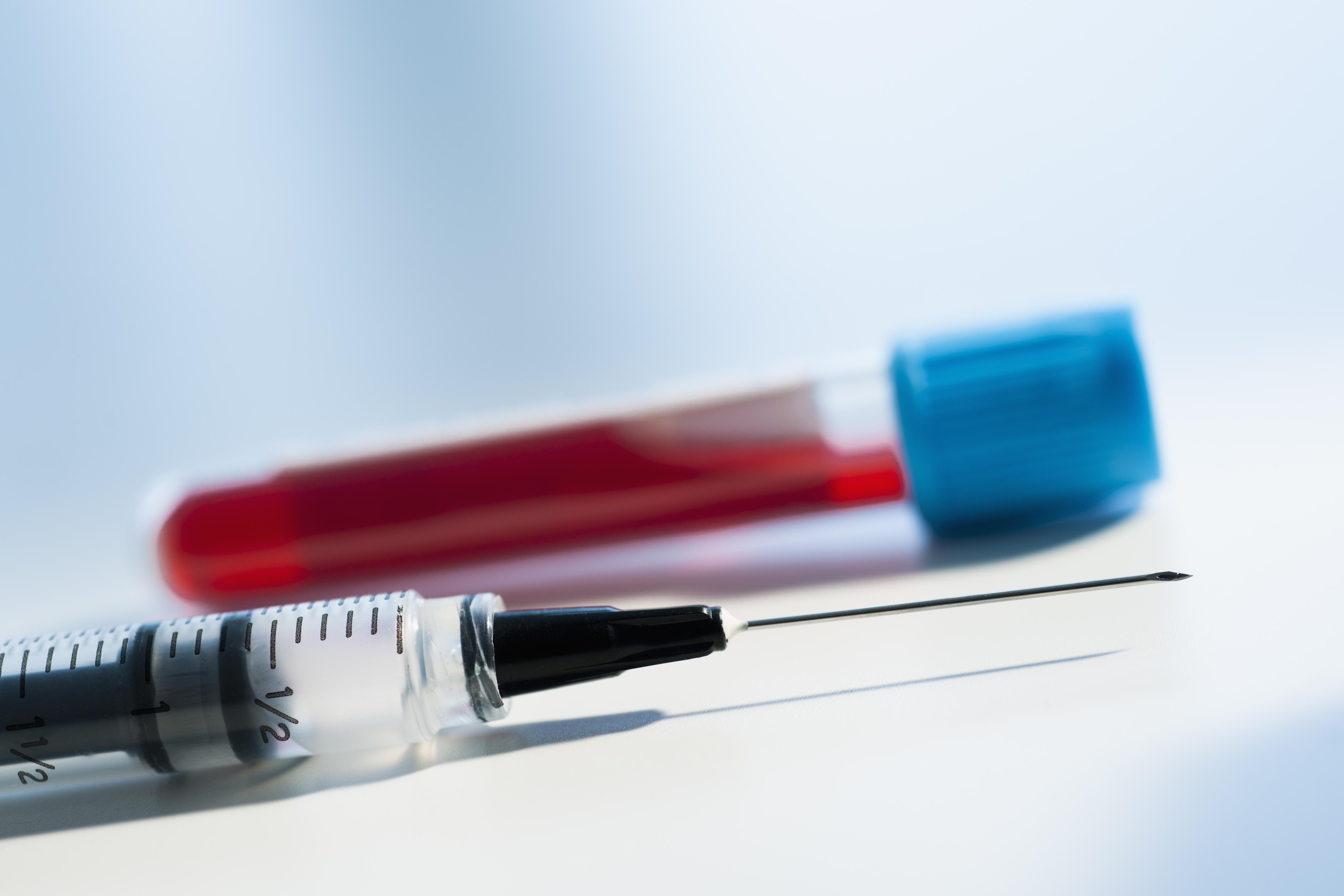 Studio shot of blood sample and syringe